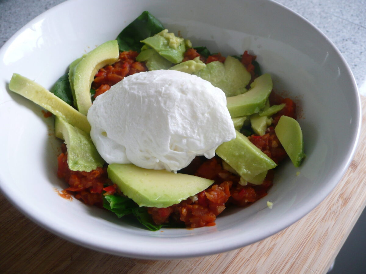 Poached egg with avocado, spinach and spicy tomato sauce